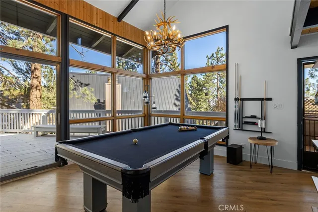 a room with pool table and windows