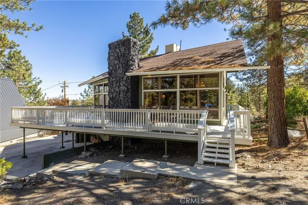 a view of a roof deck with wooden fence and floor