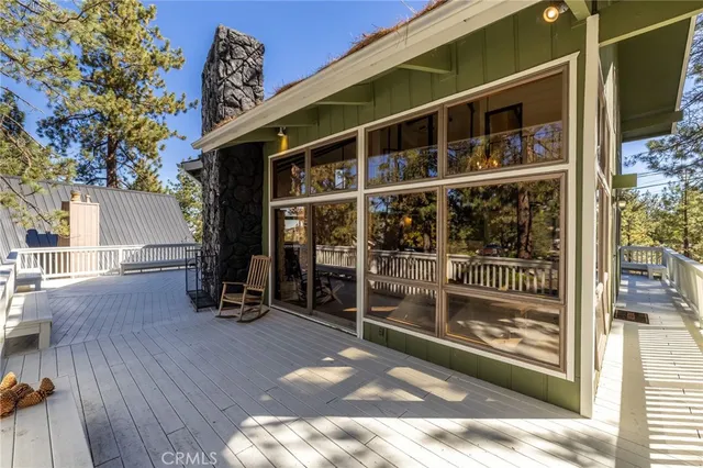 a view of a house with a large window and wooden floor