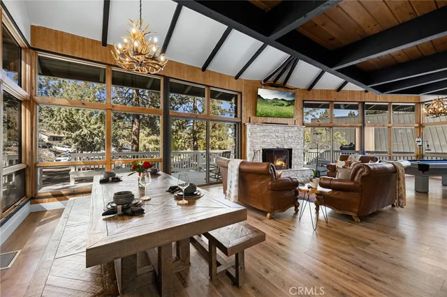 a living room with furniture a chandelier and a large window