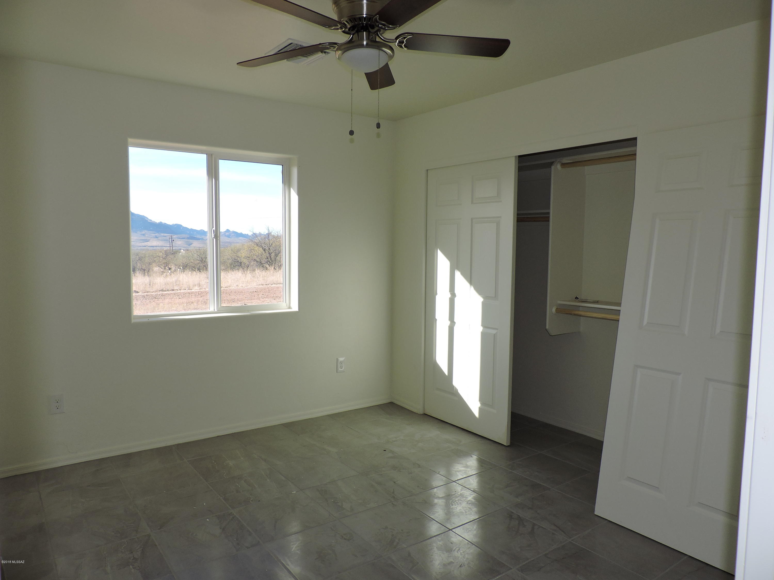 1604 Tigre Court Rio Rico, AZ 85648 - Photo 14 of 17 an empty room with windows and closet