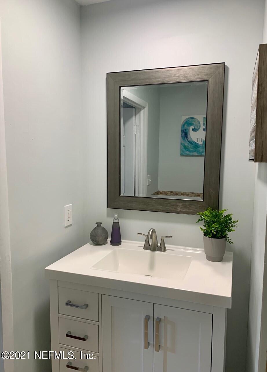 11661 Dewitt Road Jacksonville, FL 32218 - Photo 12 of 14 a bathroom with a sink and a mirror