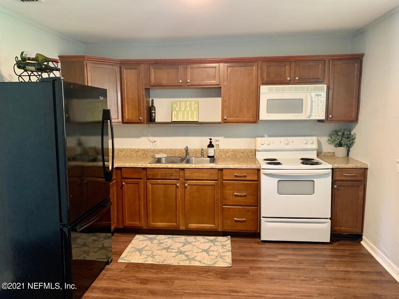 11661 Dewitt Road Jacksonville, FL 32218 - Photo 2 of 14 a kitchen with a stove microwave and refrigerator