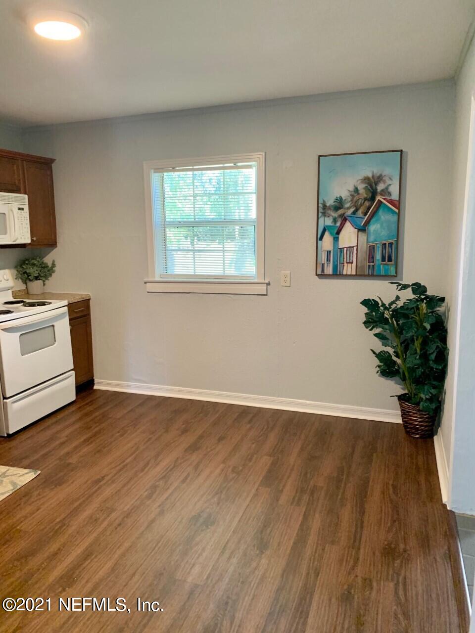11661 Dewitt Road Jacksonville, FL 32218 - Photo 3 of 14 a view of a room with wooden floor and white walls