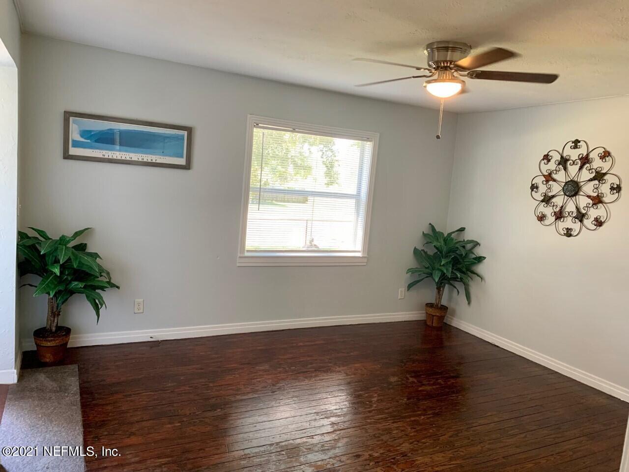 11661 Dewitt Road Jacksonville, FL 32218 - Photo 5 of 14 a living room with wooden floor and a potted plant