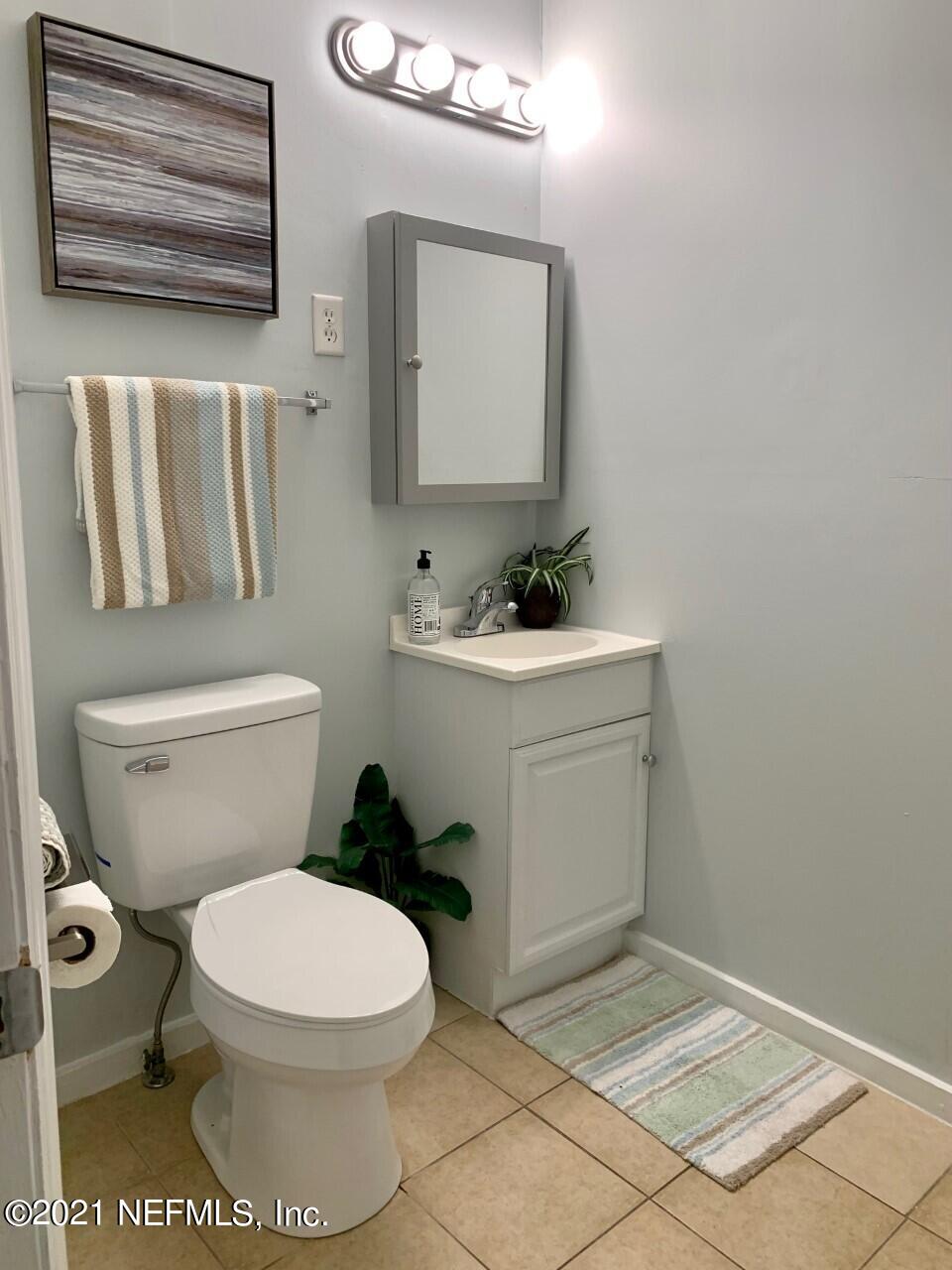 11661 Dewitt Road Jacksonville, FL 32218 - Photo 6 of 14 a bathroom with a toilet sink and mirror