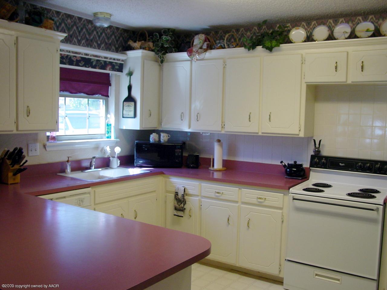 6601 Slater Circle Amarillo, TX 79110 - Photo 13 of 31 a kitchen with stainless steel appliances granite countertop a stove a sink and a microwave