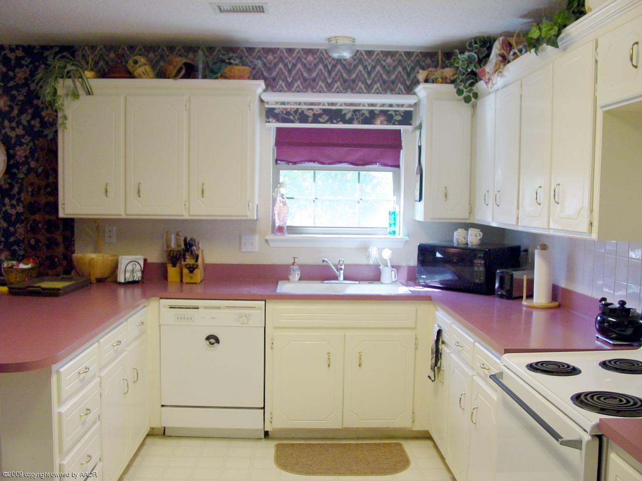 6601 Slater Circle Amarillo, TX 79110 - Photo 14 of 31 a kitchen with stainless steel appliances granite countertop a stove a sink and white cabinets