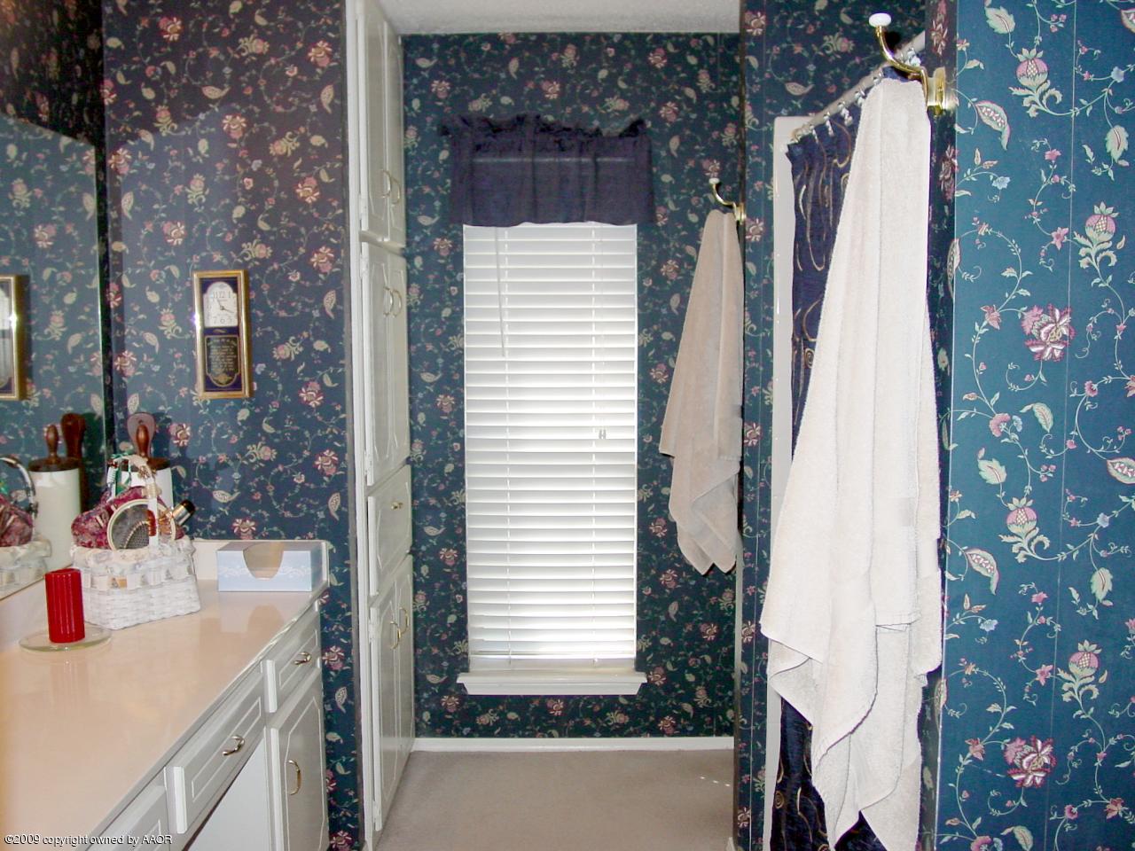 6601 Slater Circle Amarillo, TX 79110 - Photo 19 of 31 a bathroom with a sink and a mirror