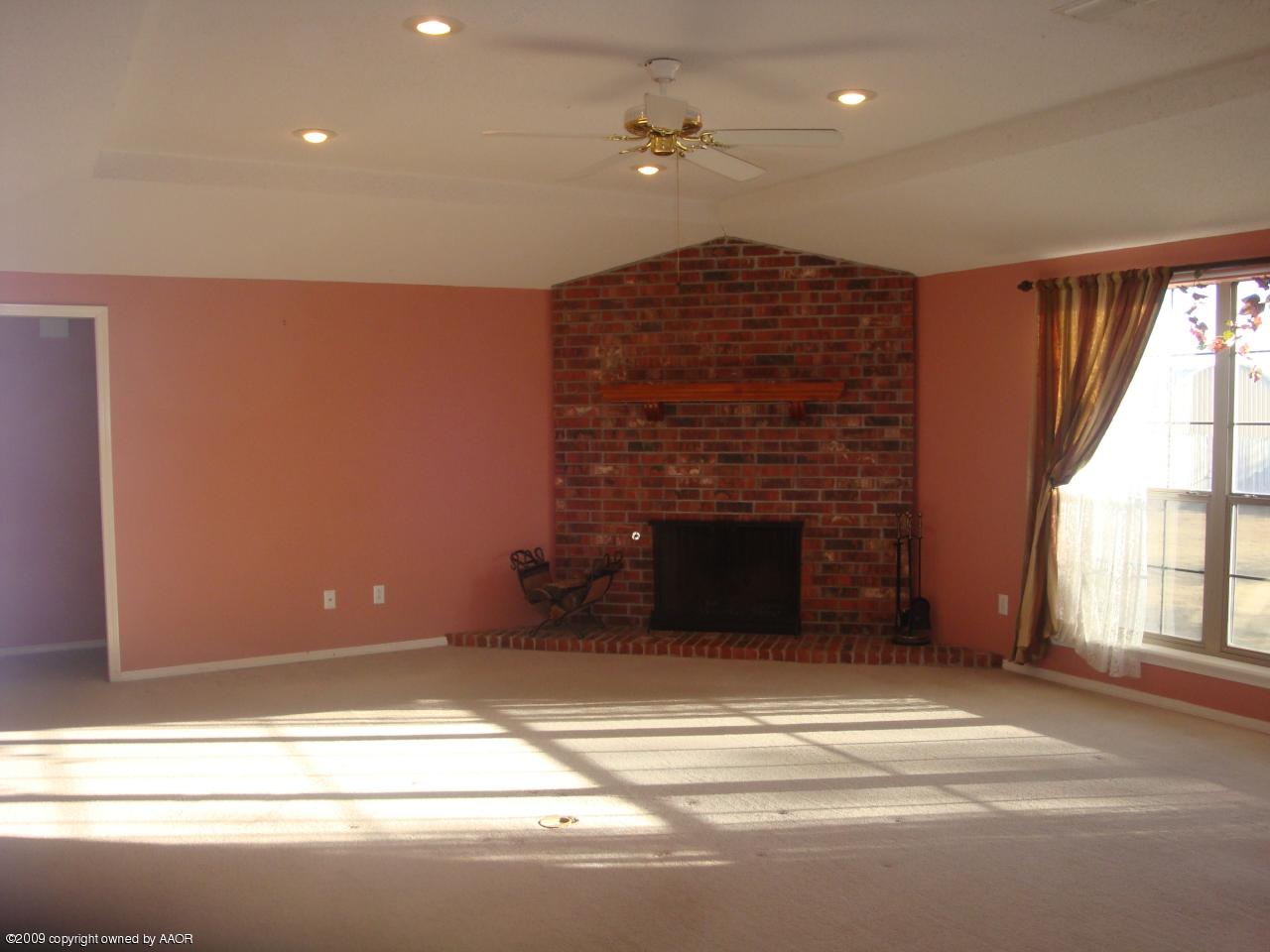6601 Slater Circle Amarillo, TX 79110 - Photo 4 of 31 a view of an empty room with a fireplace and a window