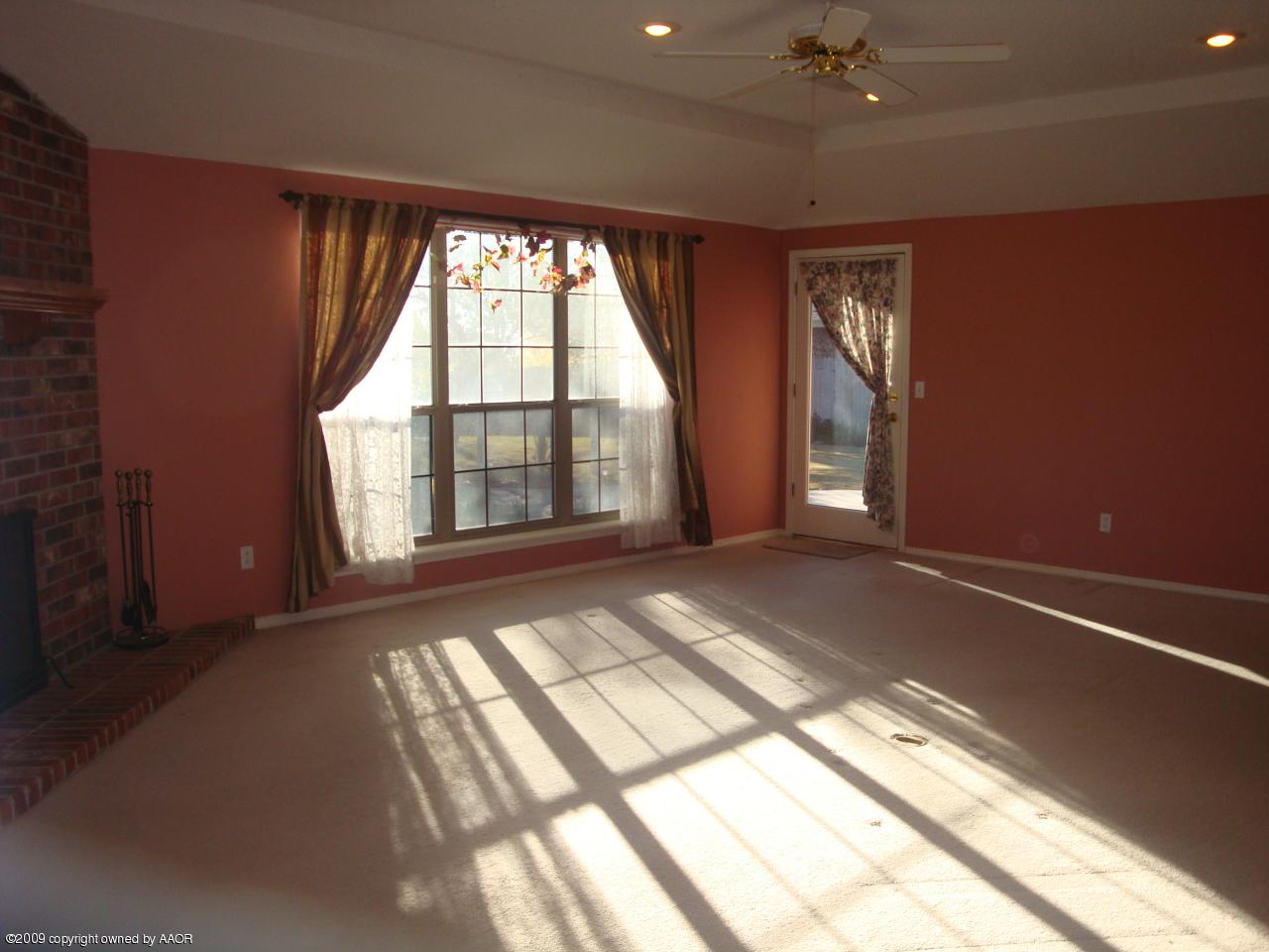 6601 Slater Circle Amarillo, TX 79110 - Photo 9 of 31 a view of an empty room with a fireplace and a window