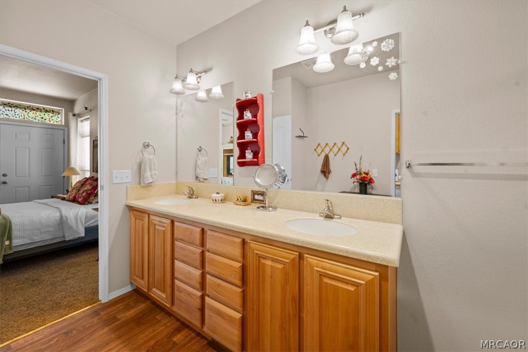 775 Riverside Avenue Sugarloaf, CA 92386 - Photo 15 of 28 a en suite bathroom with a double vanity sink and a mirror