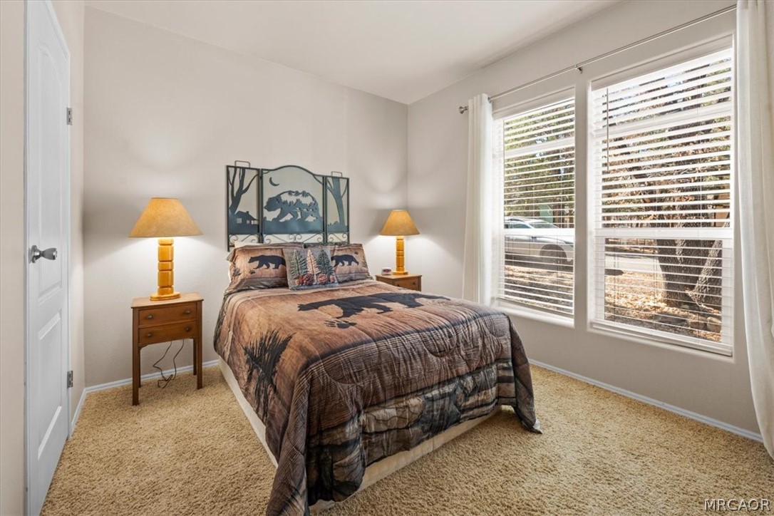 775 Riverside Avenue Sugarloaf, CA 92386 - Photo 17 of 28 a bed sitting in a bedroom next to a window