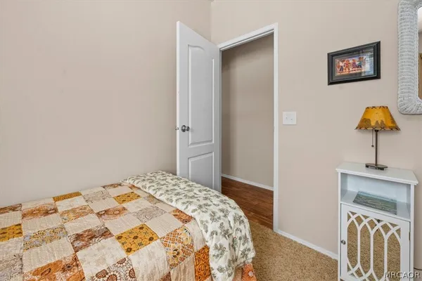 a bedroom with a bed and a lamp