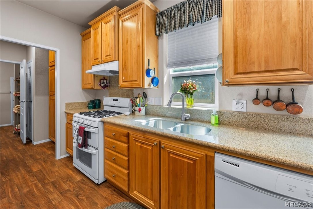 775 Riverside Avenue Sugarloaf, CA 92386 - Photo 9 of 28 a kitchen with stainless steel appliances granite countertop a sink a stove and a refrigerator