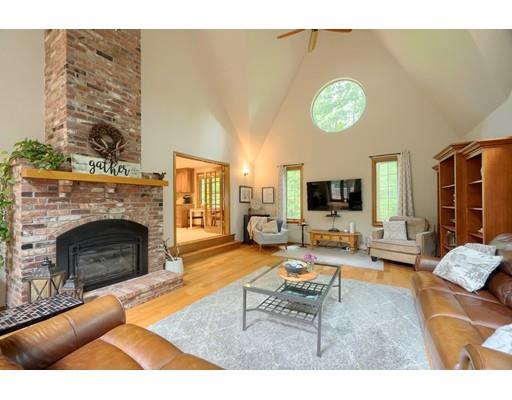 14 Deer Run Road Littleton, MA 01460 - Photo 20 of 41 a living room with furniture a fireplace and a flat screen tv