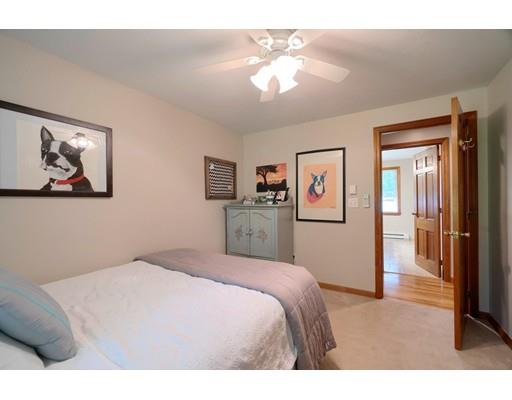14 Deer Run Road Littleton, MA 01460 - Photo 22 of 41 a bedroom with a large bed and a chandelier
