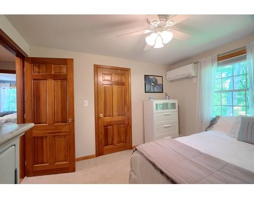 14 Deer Run Road Littleton, MA 01460 - Photo 23 of 41 a bedroom with a bed and a chandelier