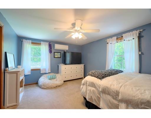 14 Deer Run Road Littleton, MA 01460 - Photo 24 of 41 a bedroom with a large bed and a chandelier