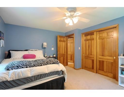 14 Deer Run Road Littleton, MA 01460 - Photo 25 of 41 a bedroom with a large bed and a chandelier