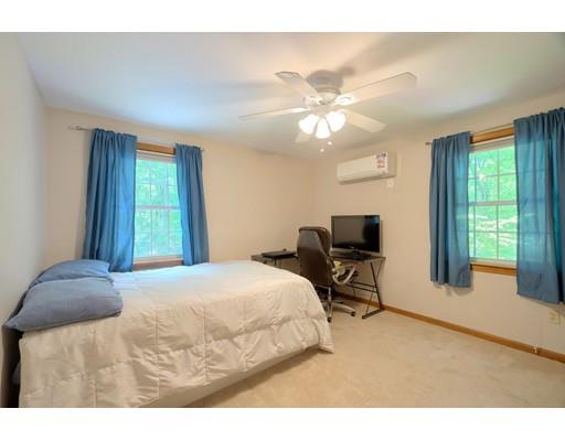 14 Deer Run Road Littleton, MA 01460 - Photo 26 of 41 a bedroom with a bed and a chandelier