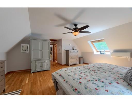 14 Deer Run Road Littleton, MA 01460 - Photo 29 of 41 a living room with a bed furniture and a wooden floor