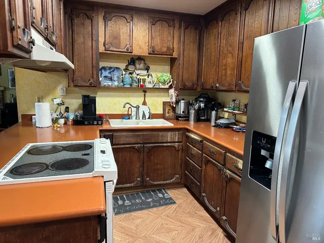 a living room with furniture a fireplace and a chandelier