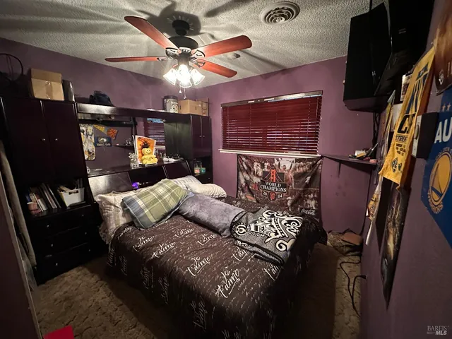 a bed sitting in a room next to a window