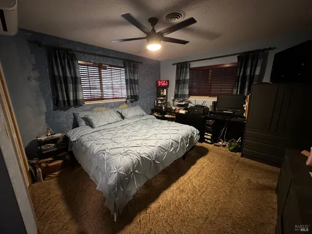 a bedroom with a bed dresser and a window