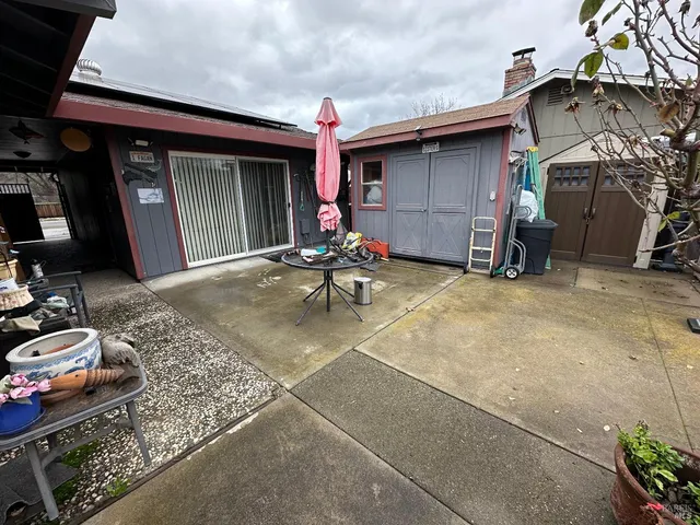 a view of a chair and tables in patio of the house