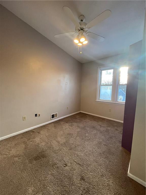 3479 Brodhead Road Monaca, PA 15061 - Photo 10 of 21 en empty room with windows and ceiling fan
