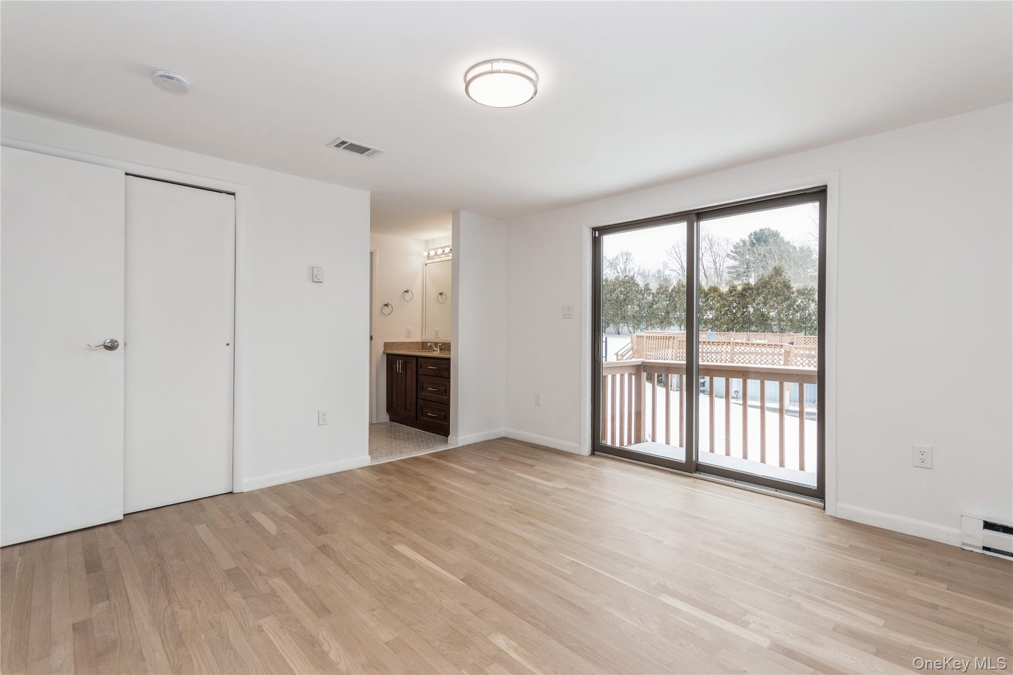 20 Lake Road Mahopac, NY 10541 - Photo 11 of 48 a view of an empty room with a window and wooden floor