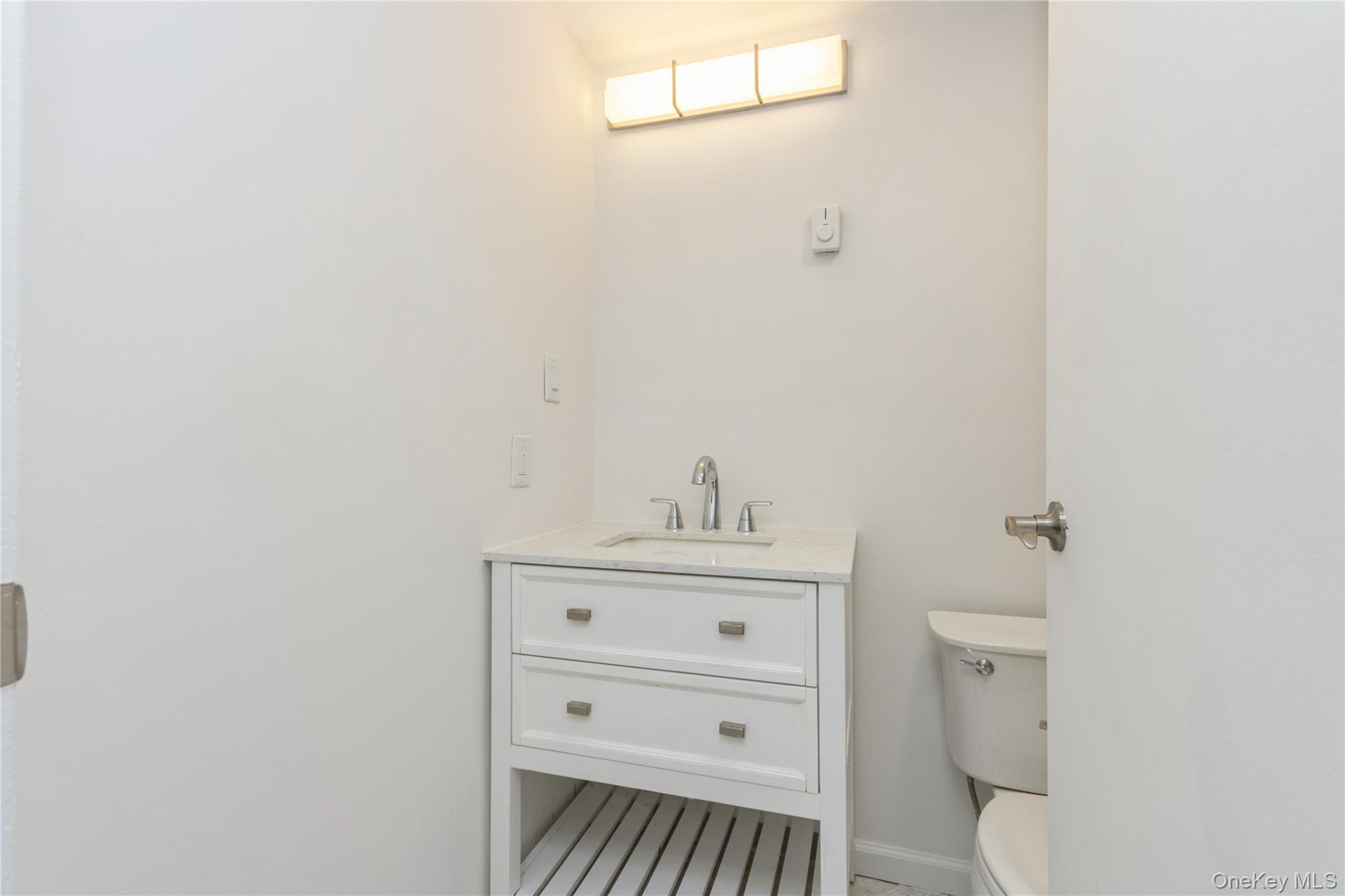 20 Lake Road Mahopac, NY 10541 - Photo 18 of 48 a bathroom with a sink a toilet and a window
