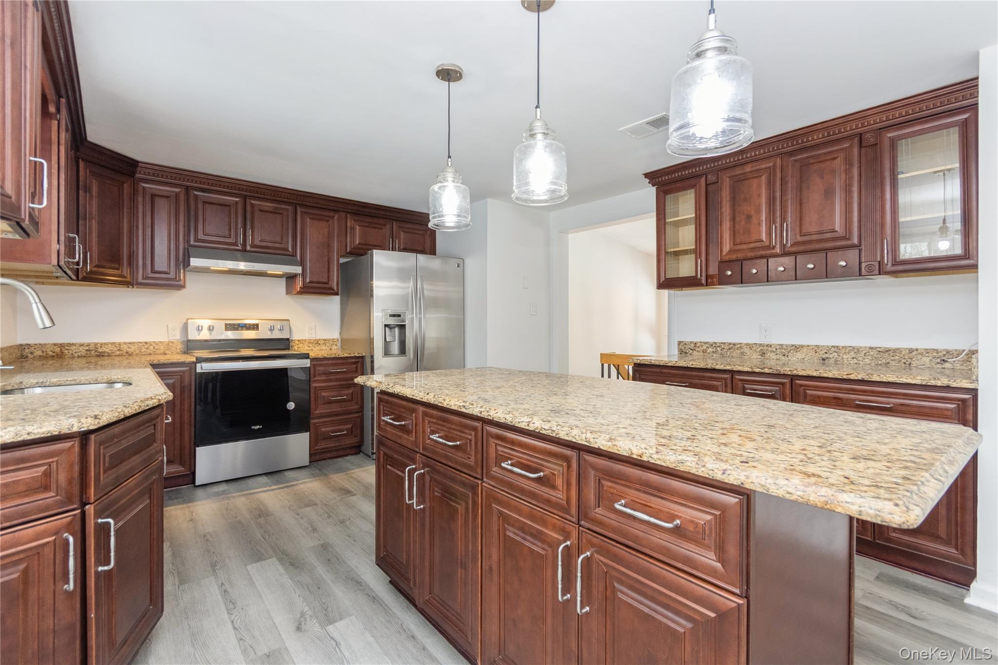 20 Lake Road Mahopac, NY 10541 - Photo 24 of 48 a kitchen with granite countertop wooden cabinets and a wooden floor