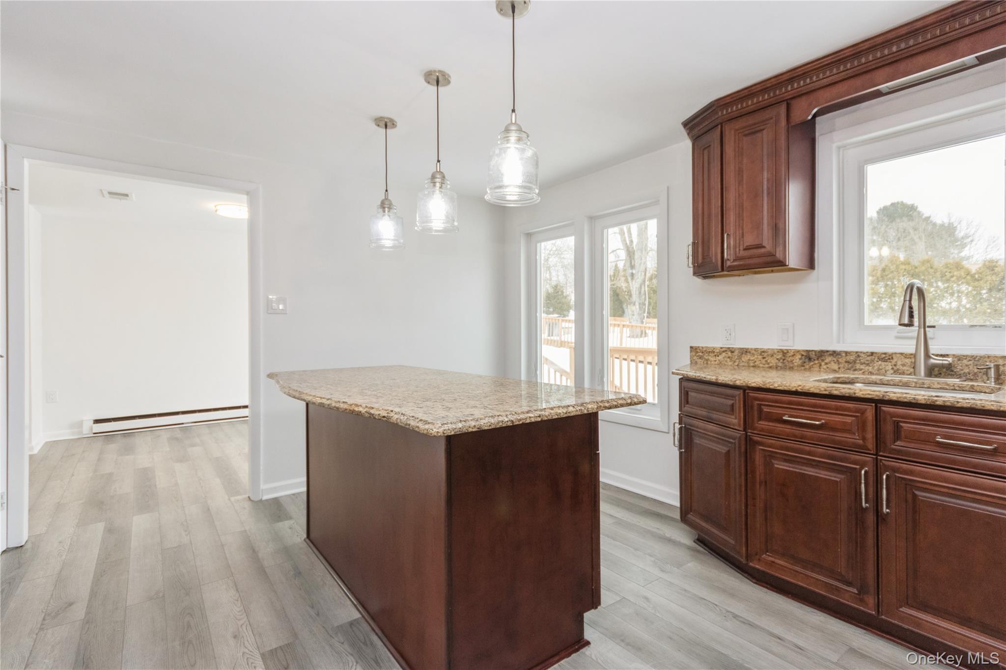 20 Lake Road Mahopac, NY 10541 - Photo 26 of 48 a kitchen with granite countertop a sink and a stove with wooden floor