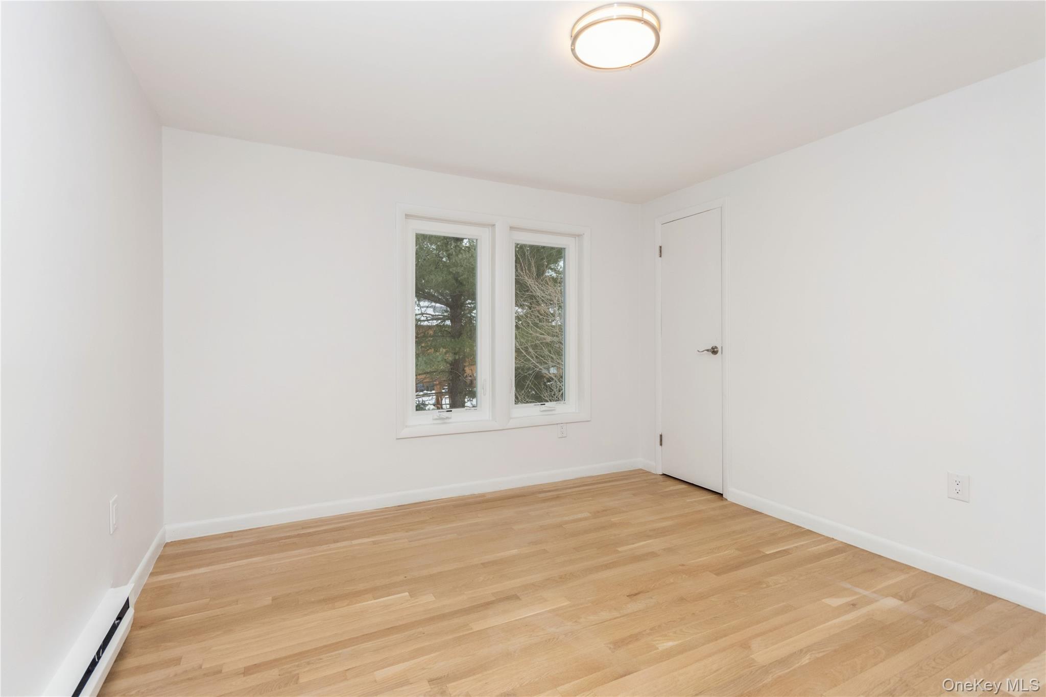 20 Lake Road Mahopac, NY 10541 - Photo 6 of 48 an empty room with wooden floor and windows