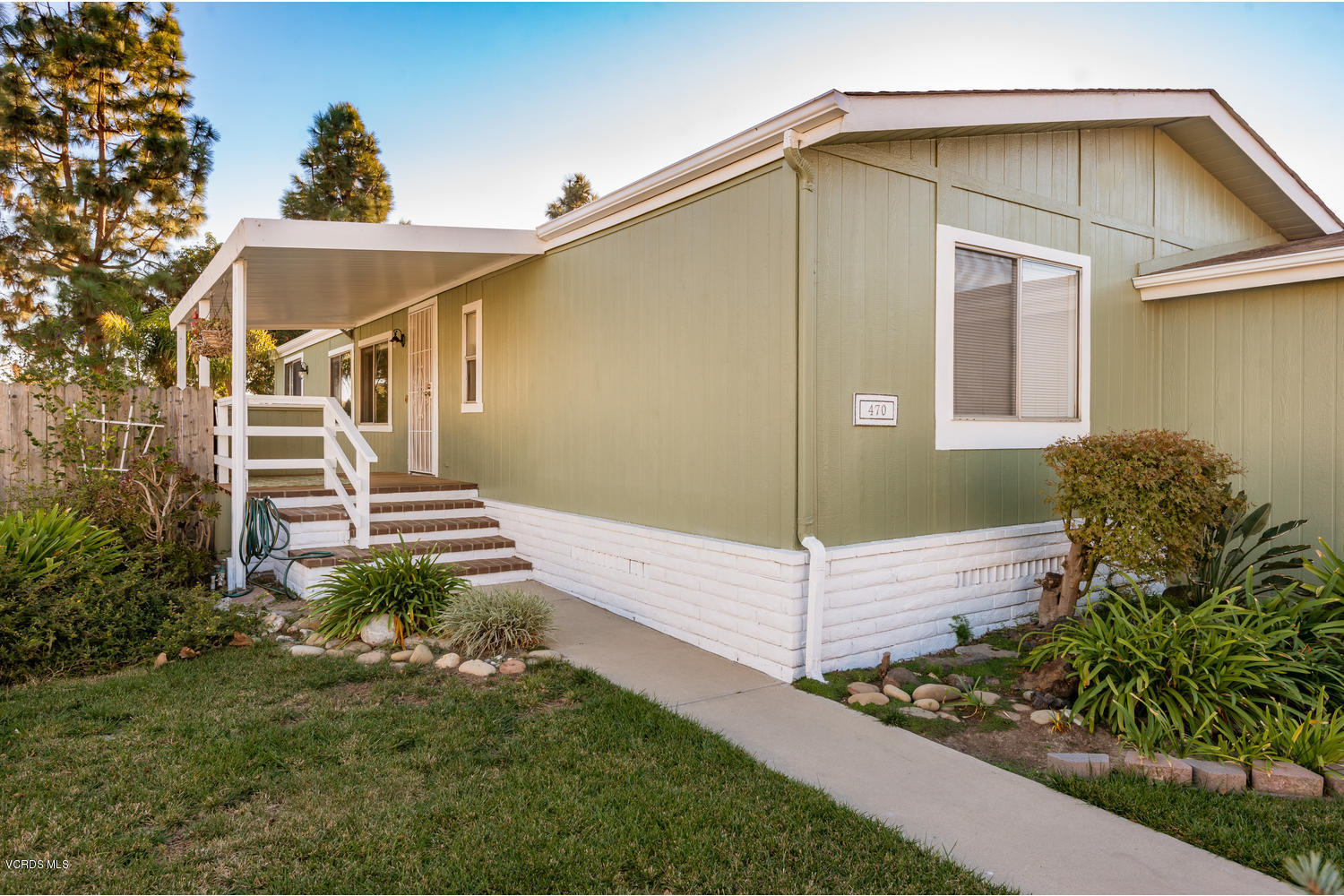 470 Raspberry Place, Unit 30 Oxnard, CA 93036 - Photo 2 of 21 a front view of a house with a yard