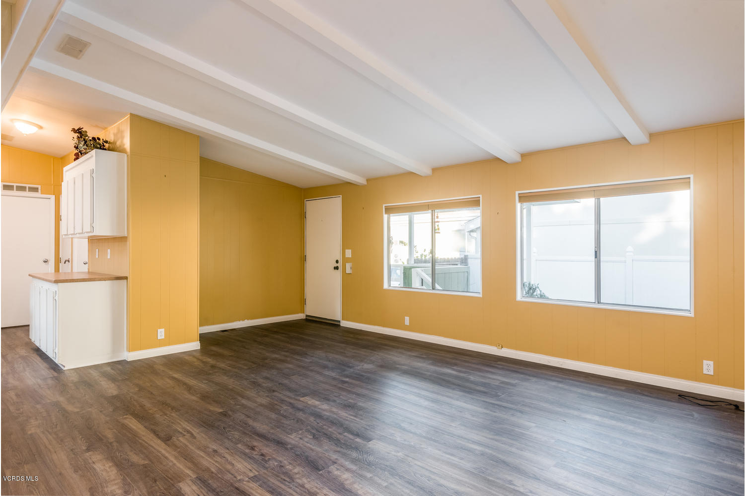 470 Raspberry Place, Unit 30 Oxnard, CA 93036 - Photo 5 of 21 an empty room with wooden floor and windows