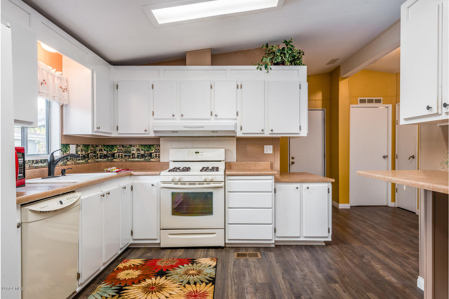 470 Raspberry Place, Unit 30 Oxnard, CA 93036 - Photo 7 of 21 a kitchen with granite countertop a stove a sink and a refrigerator
