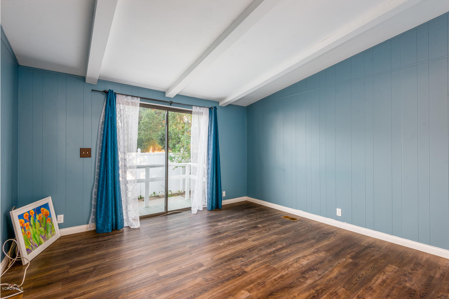 470 Raspberry Place, Unit 30 Oxnard, CA 93036 - Photo 9 of 21 an empty room with wooden floor and a window