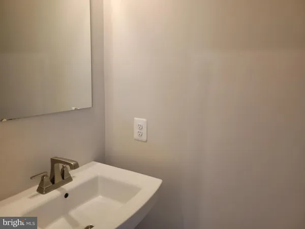 a bathroom with a sink and mirror