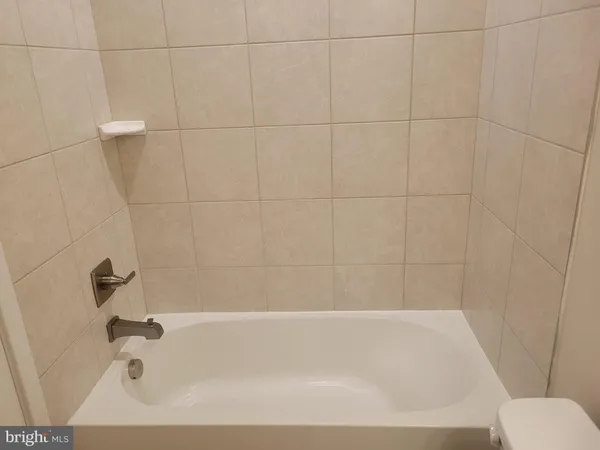 a bathroom with a shower and a bath tub