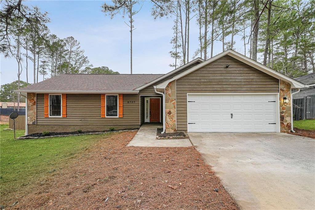 8737 Edenton Way Jonesboro, GA 30238 - Photo 1 of 1 a front view of a house with a yard and garage
