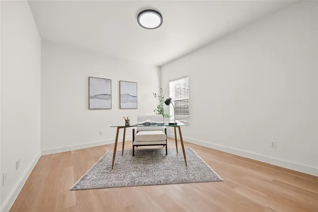 a dining room with wooden floor and a window
