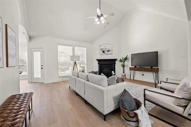 a living room with furniture a flat screen tv and a fireplace