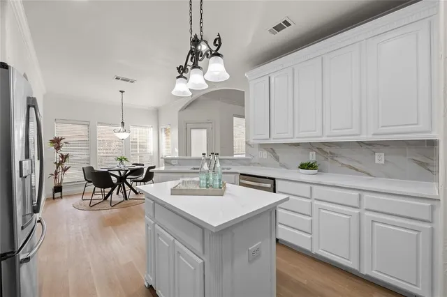 a view of a kitchen sink microwave and cabinets