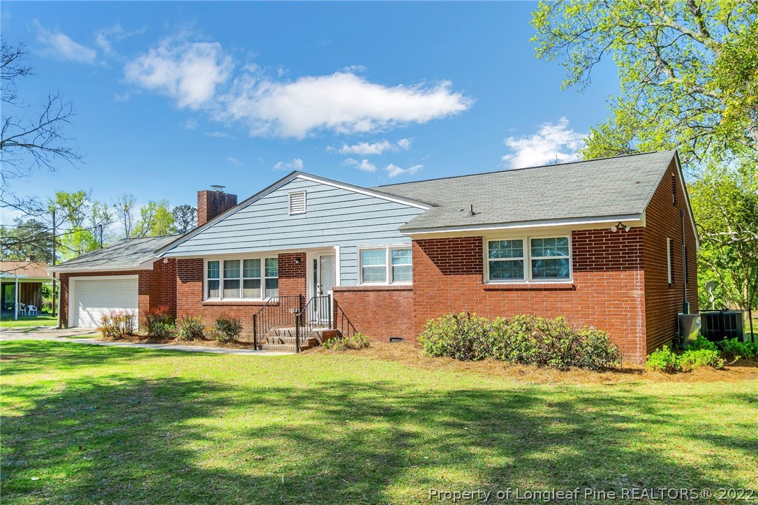 a front view of house with yard and green space