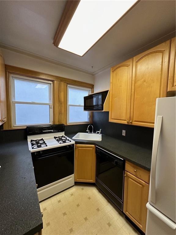 9111 Colonial Road Brooklyn, NY 11209 - Photo 12 of 15 a kitchen with stainless steel appliances granite countertop a stove a sink and a microwave