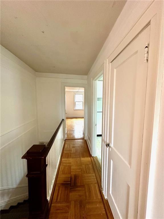 9111 Colonial Road Brooklyn, NY 11209 - Photo 13 of 15 a view of a hallway with wooden floor and staircase