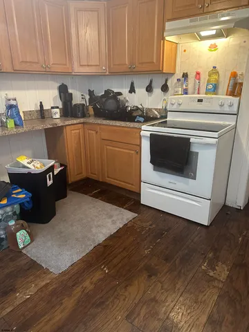 a kitchen with stainless steel appliances granite countertop a sink stove and microwave